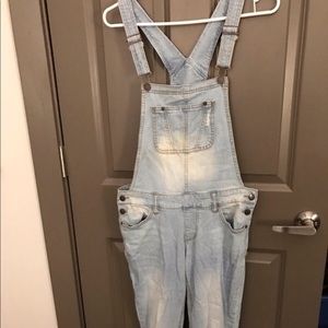 Light-wash distressed denim overalls